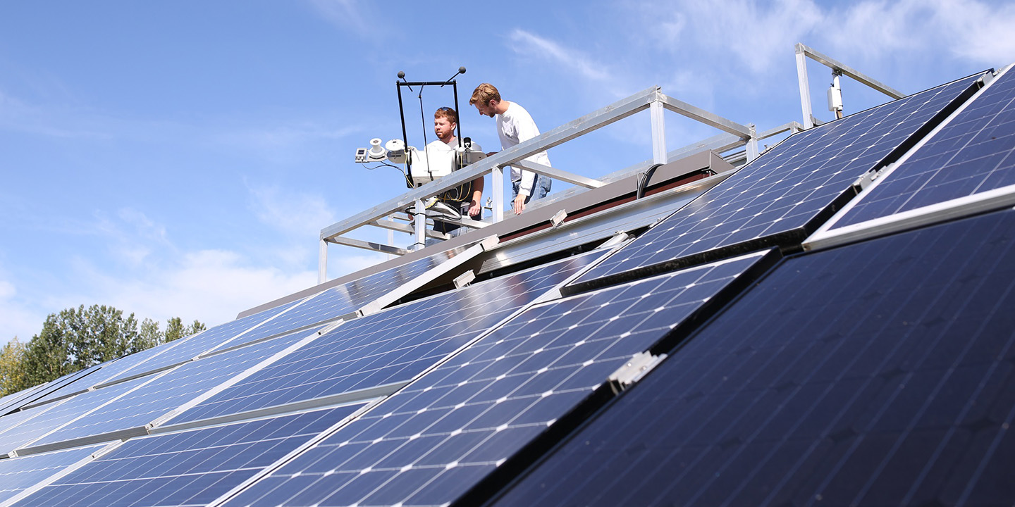 STEP team members work on solar panel