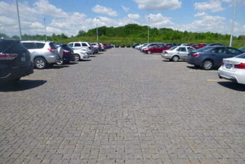A large permeable pavement parking lot with cars.