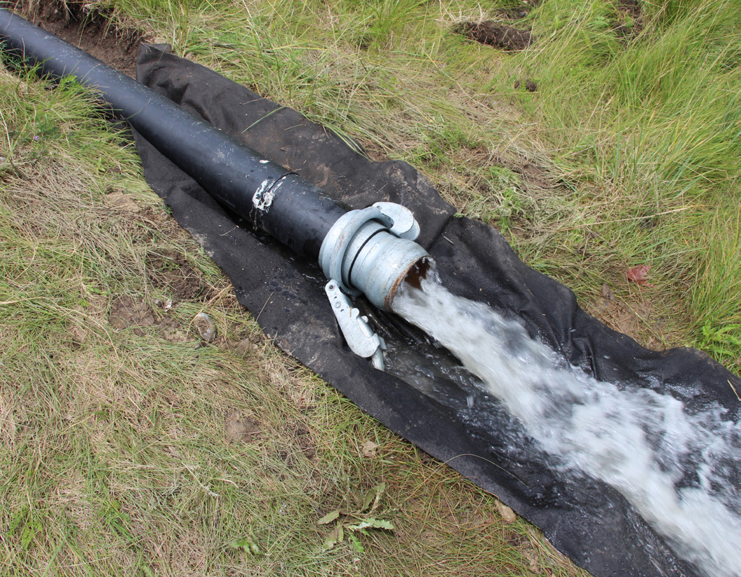 Figure 7. Clear water exiting the sediment dewatering bags.