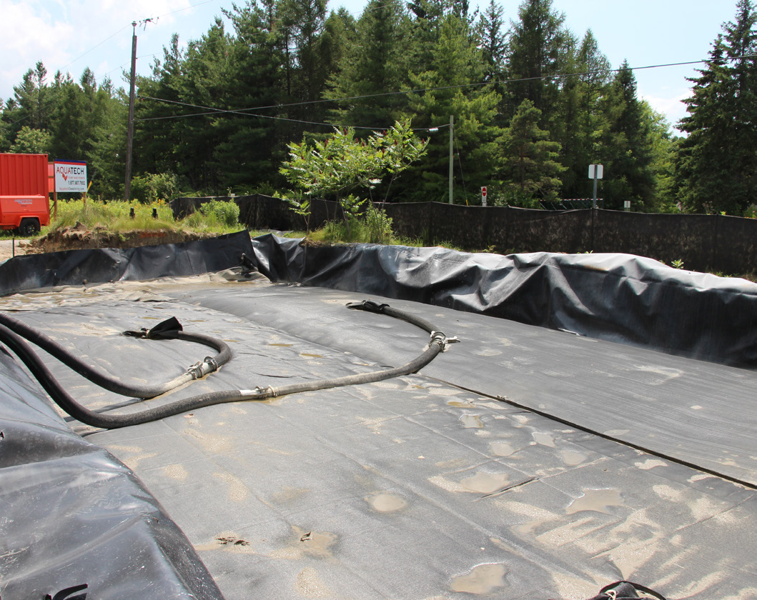 Figure 6. Sediment dewatering bags. Hoses are laid across the surface.